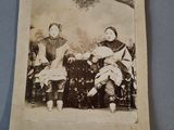 an old photo of two women sitting on a bench