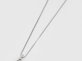 a close up of a necklace on a white surface