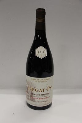 a bottle of wine sitting on top of a white table