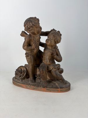 statue of a boy and a girl sitting on a rock with a dog