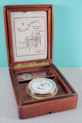 a small wooden box with a clock inside of it