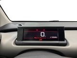 the dashboard of a car with a digital clock on it