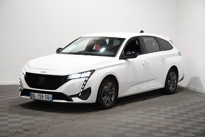 the white car is parked in a room with a checkered floor