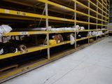 many shelves with rolls of paper on them in a warehouse