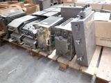 a pile of old machinery sitting on a pallet in a warehouse
