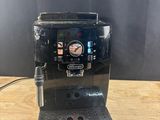 a black coffee machine sitting on top of a wooden table