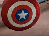 a captain america shield on the back of a gym bench