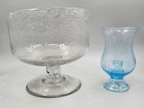 two glass vases sitting next to each other on a table