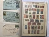 an open book with stamps on it sitting on a table