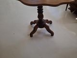 a table with a flower shaped top in a living room