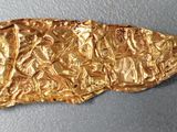 a piece of gold that is on a table