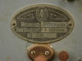 a close up of a metal plate with a number on it