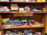 a wooden shelf filled with lots of toys in a store