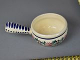 a small cup with a brush in it on a table