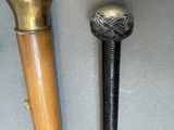 two different types of baseball bats on the table