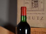 a bottle of wine sitting on a table next to a box