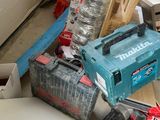 a pile of tools sitting on the floor in a garage