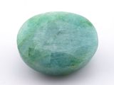 a green ball on a white surface with a white background