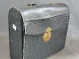 an old suitcase sitting on the floor with a tag on it