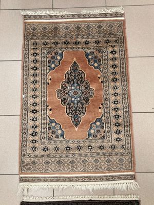 rug on the floor in a room with a white tile floor