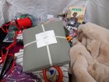 a teddy bear that is sitting next to a pile of clothes