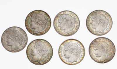 six different british coins are arranged in a circle on a white surface