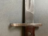 a close up of a knife on a metal surface