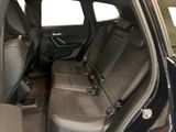 the back seats of a black car are empty in the room