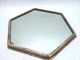 a close up of a mirror on a table with a white background