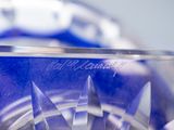 a close up of a glass bowl with knives in it