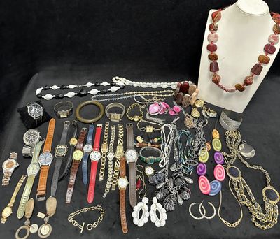 many different types of jewelry displayed on a table