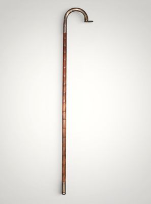 an old cane with a wooden handle on a white background