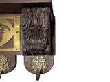 a wooden clock with a lion head on the front of it