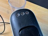 a glass of water next to a blender on a wooden table