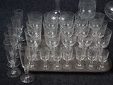 a tray of wine glasses and a bottle on the table