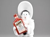 a figurine of a woman holding a bottle of ketchup