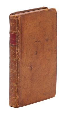 an old book sitting on top of a table next to a white background