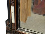 a mirror that is sitting on a table with a cloth hanging on it