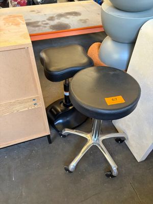 a stack of chairs and a stool in a room
