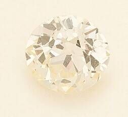 a close up of a white diamond on a white surface