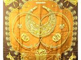 a close up of a brown and yellow scarf with gold designs on it