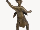 bronze figurine of a boy with a hat on his head