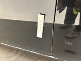 a person standing in front of a mirror with a sticker on it
