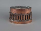 an image of a copper ring sitting on top of a table