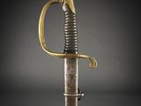 an old sword with a gold handle on a black background