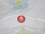 a plastic container with a flower inside of it