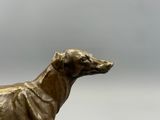 a statue of a dog that is standing on a pedestal