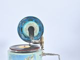 a blue and white music box on a white surface
