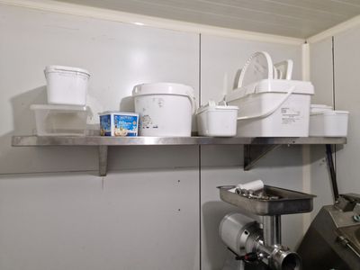 a kitchen with a lot of pots and pans on the shelves