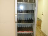a coca cola cooler in the corner of a room
